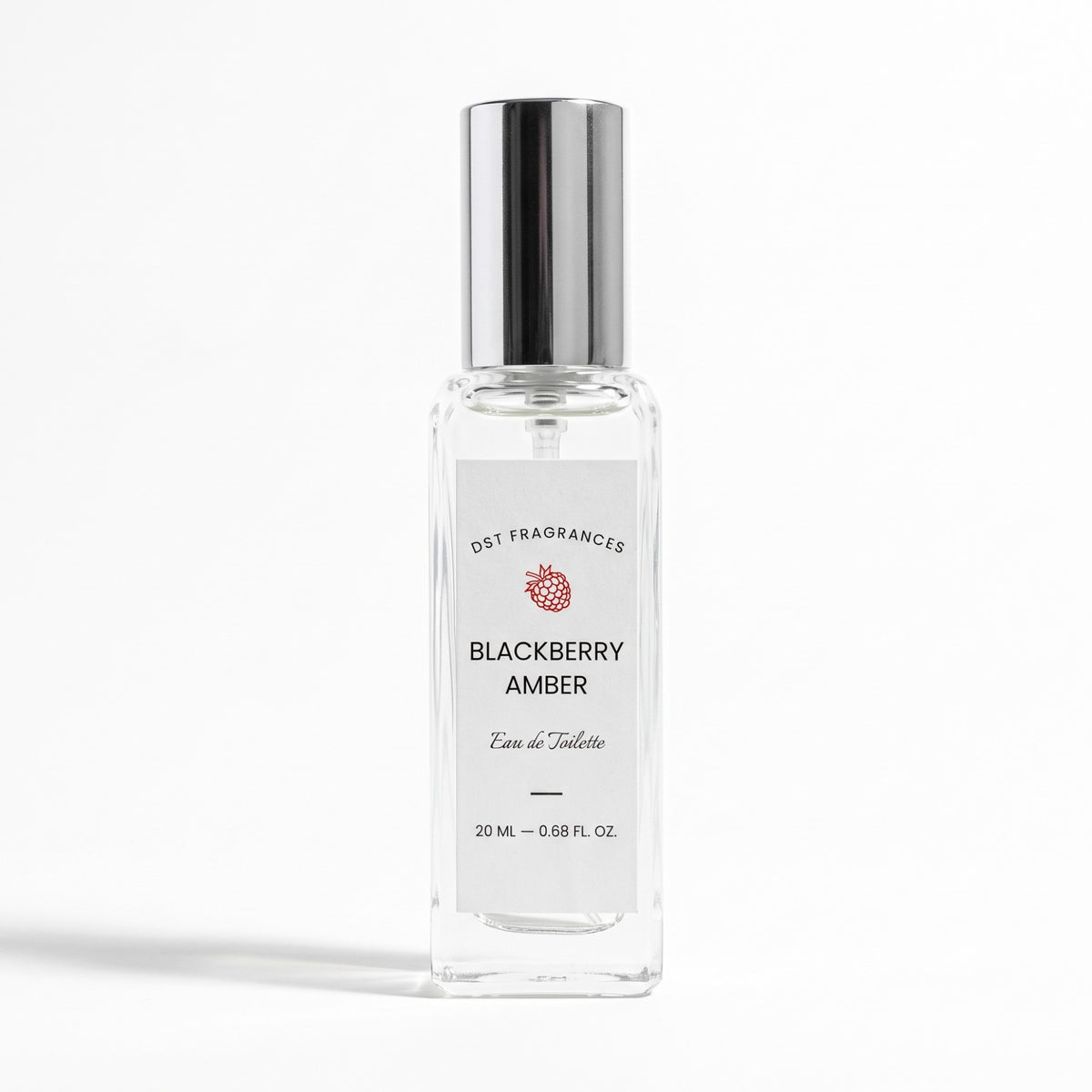 A clear glass perfume bottle with a reflective silver cap and a white label reading 'Blackberry Amber' by DST Fragrances, set against a clean white background.