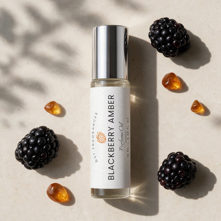 A clear perfume oil bottle labeled &