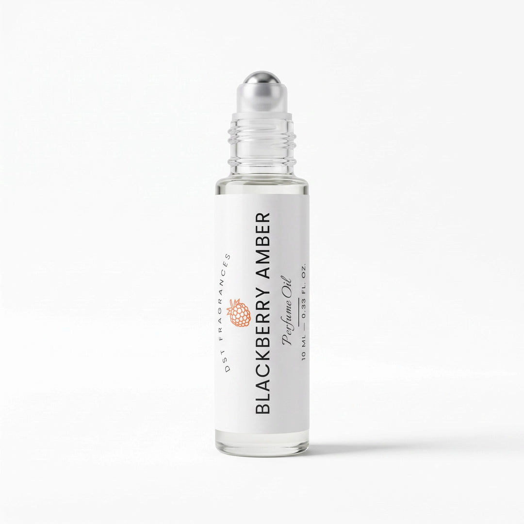 A clear glass rollerball bottle of DST Fragrances Blackberry Amber perfume oil with a white label and silver cap, set against a clean white background.