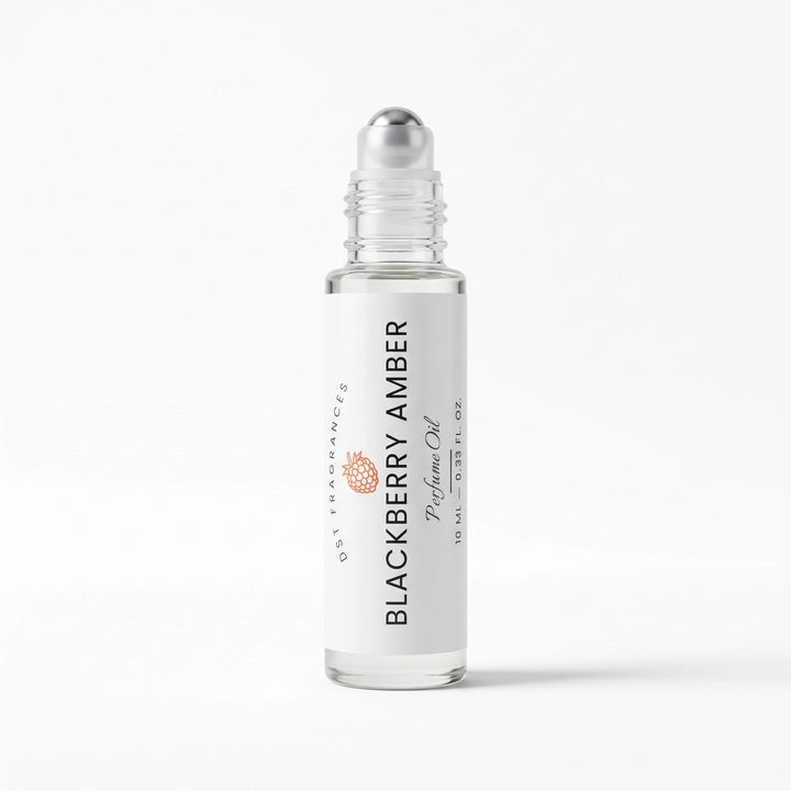 A clear glass rollerball bottle of DST Fragrances Blackberry Amber perfume oil with a white label and silver cap, set against a clean white background.