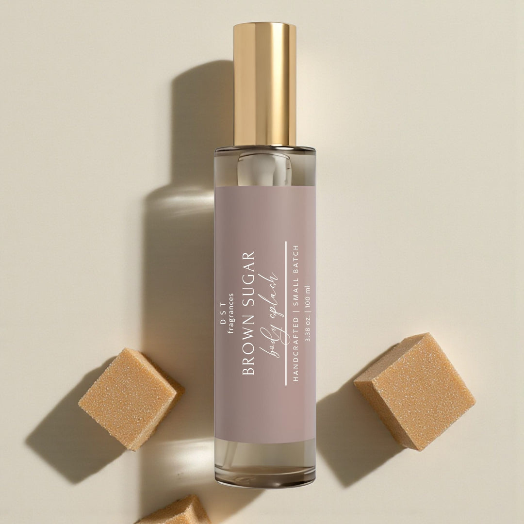 Brown Sugar Body Splash bottle with gold cap and brown label on a beige background