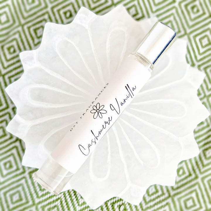 10ml bottle of Cashmere Vanilla perfume oil against a grey background. 