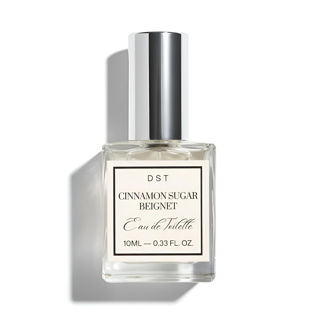 Perfume bottle labeled 'Cinnamon Sugar Beignet' by DST on a white background