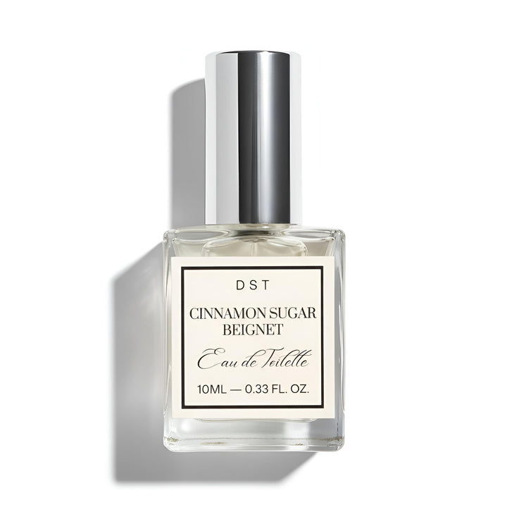 Perfume bottle labeled 'Cinnamon Sugar Beignet' by DST on a white background