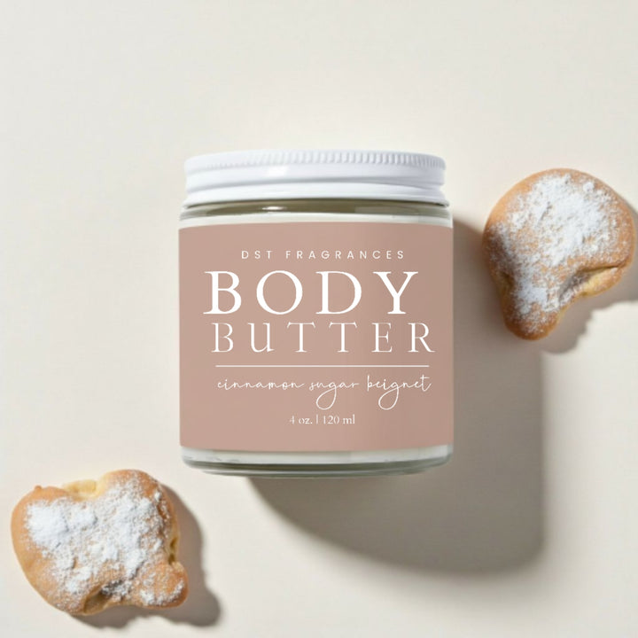 Jar of Cinnamon Sugar Beignet Body Butter with beignets on an ivory background.