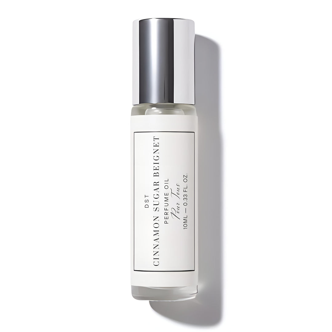 Perfume oil bottle labeled 'Cinnamon SugarBeignet' on a white background