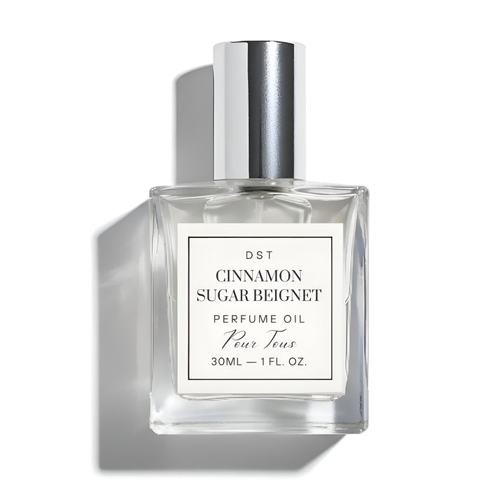 Perfume oil bottle labeled 'Cinnamon Sugar Beignet' on a white background
