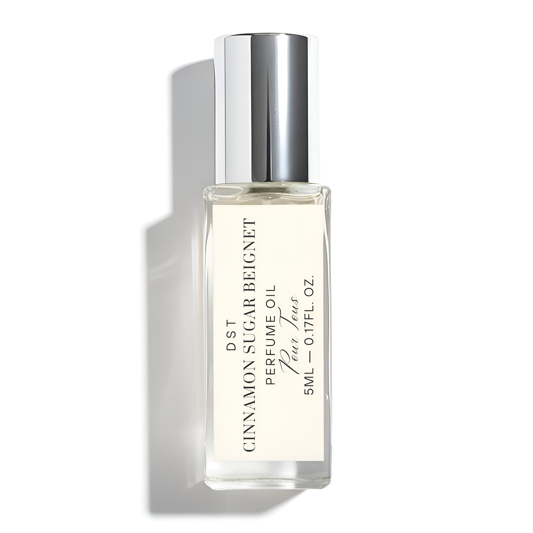 Perfume bottle labeled 'Cinnamon Sugar Beignet' on a white background