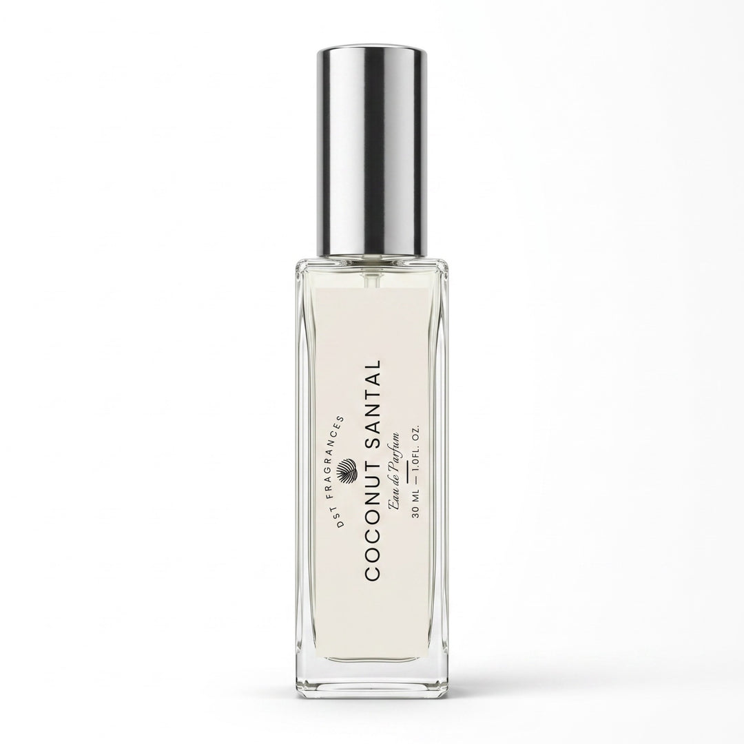 A clear glass roll-on perfume bottle with a reflective silver cap, containing a very pale warm cream liquid. The bottle features a white label with black text reading &