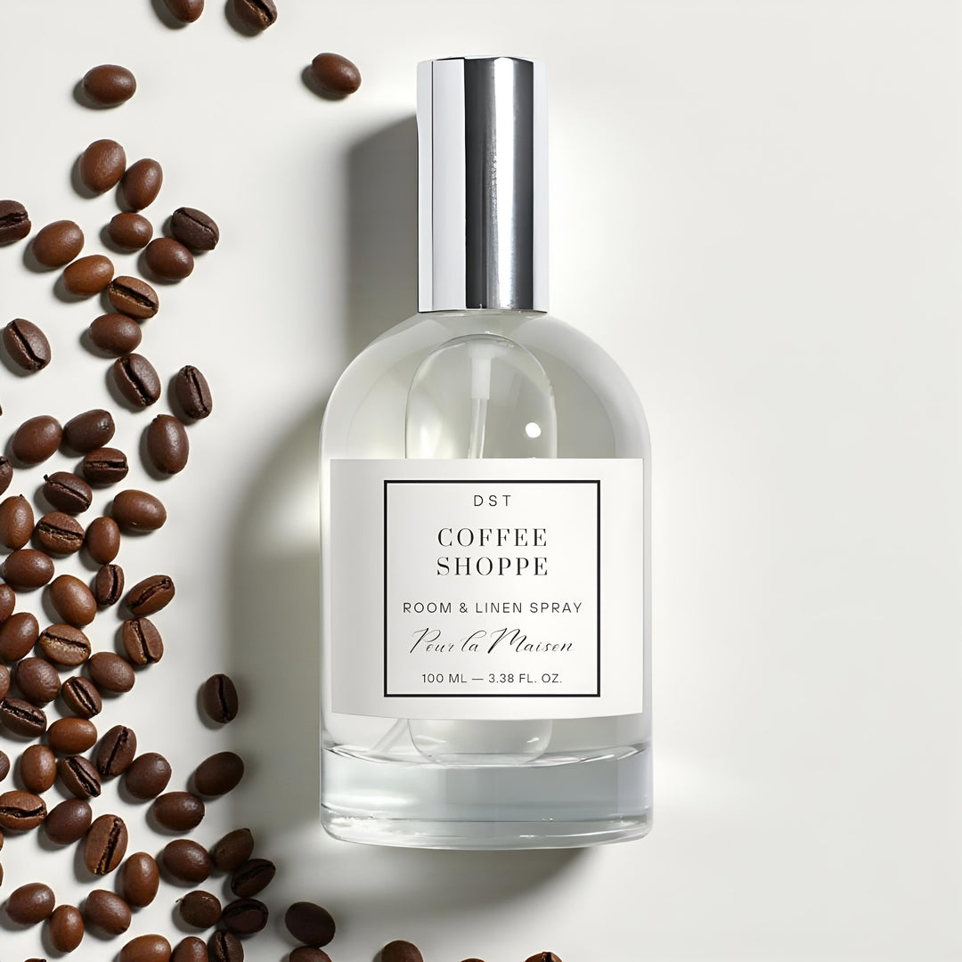 Room spray bottle labeled 'Coffee Shoppe' with coffee beans on a light background