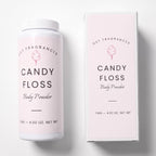 A white bottle and matching rectangular box for DST Fragrances Candy Floss Body Powder, both with pale pink labels and black text, photographed on a clean white background.