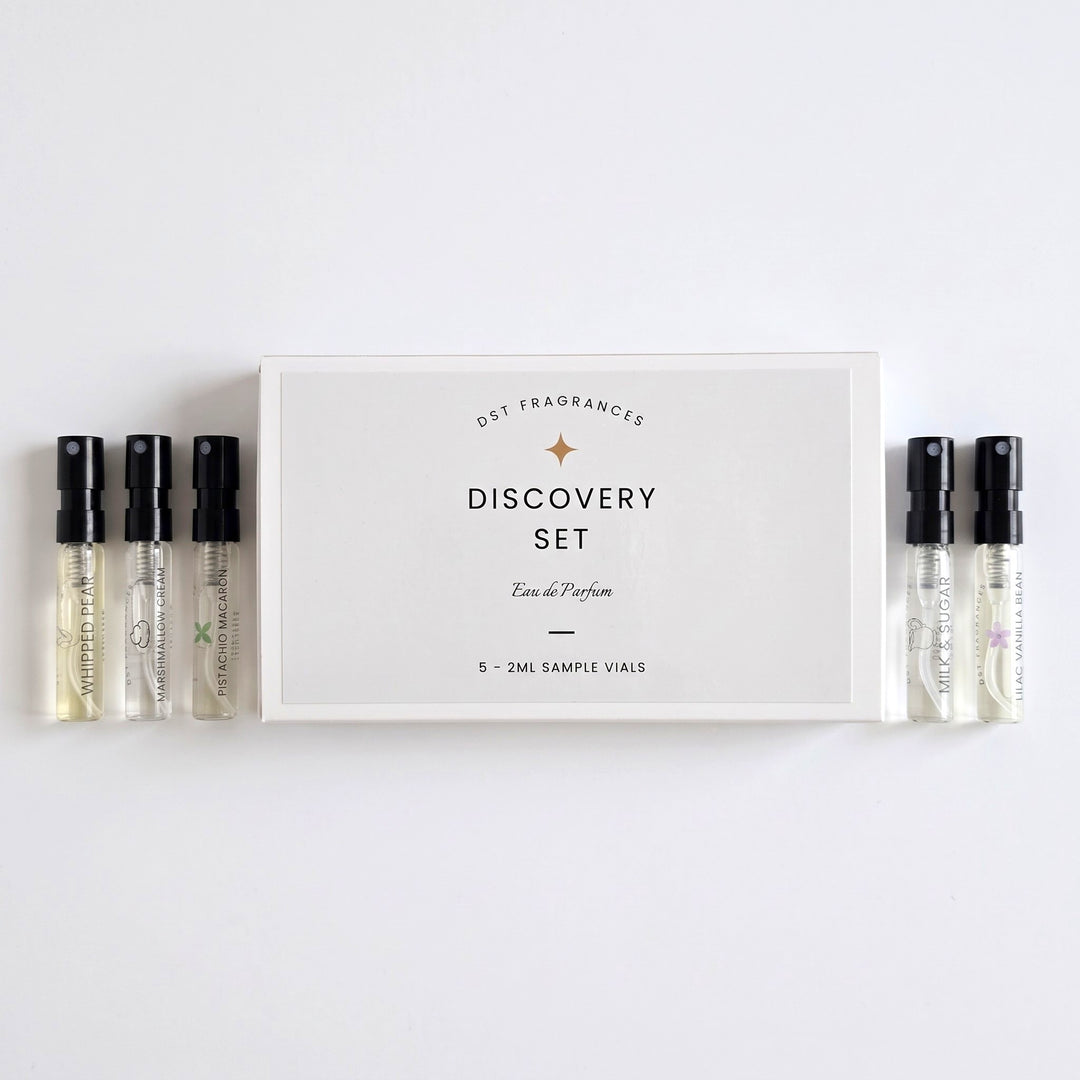 5 2ml Sample Vials of Eau de Parfum by DST Fragrances laying next to its box on a white background.