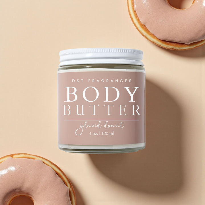 Jar of body butter labeled 'glazed donut' by DST Fragrances on a beige background with donuts.