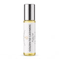 A 10 mL glass rollerball bottle of DST Fragrances Golden Fig Cashmere perfume oil, featuring a white label and a reflective silver cap, set against a plain white background.