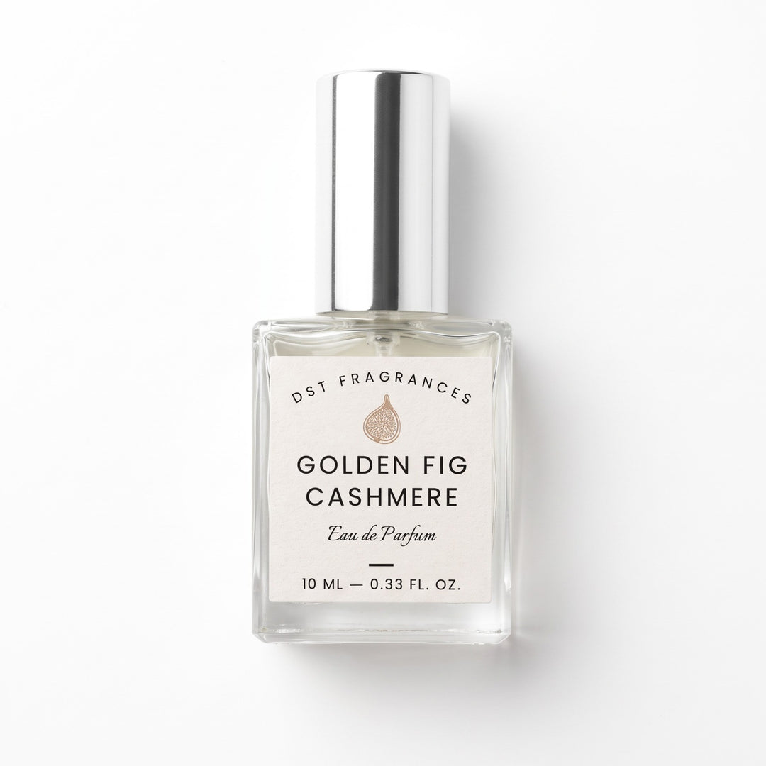 A 10 mL clear glass perfume bottle with a silver cap and a white label reading &