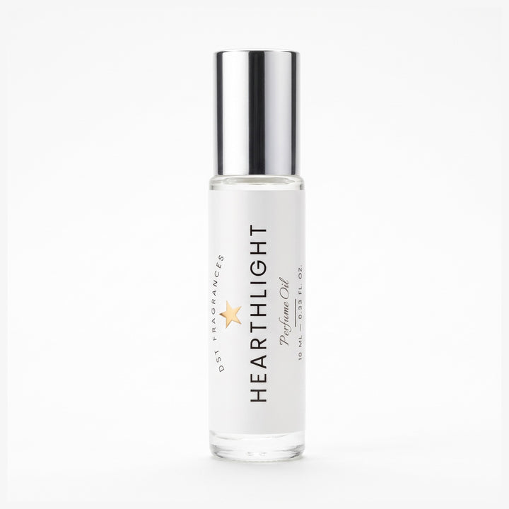 A clear glass roll-on bottle of Heartlight Perfume Oil with a reflective silver cap, set against a seamless white background.