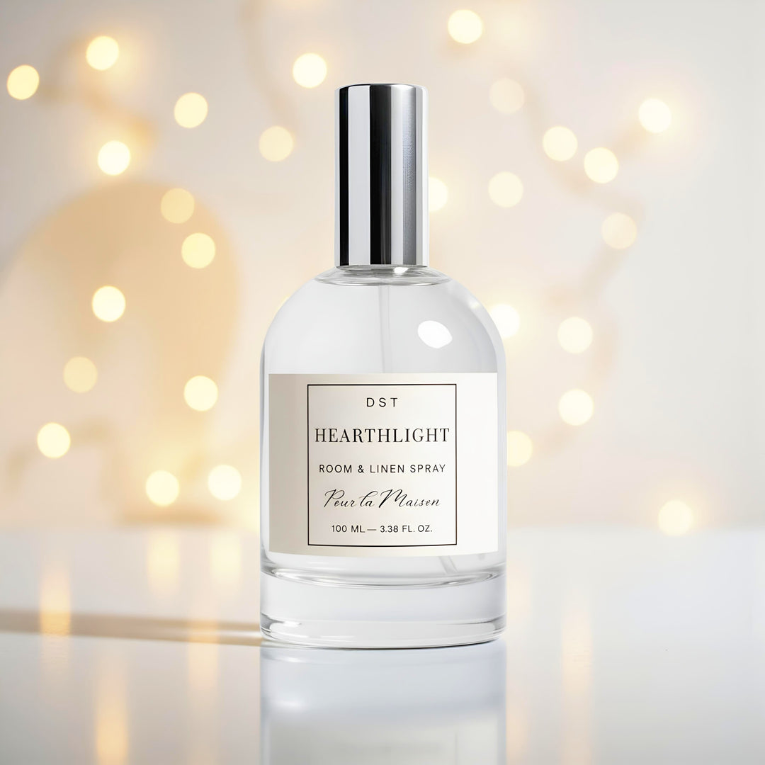 Bottle of DST Hearthlight room and linen spray with a blurred light golden bokeh background