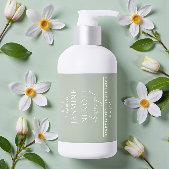 240ml bottle of Jasmine Neroli Scented Body Wash by DST Fragrances against a green background with jasmine flowers and green leaves.