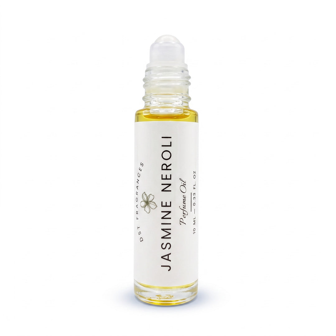 A clear glass rollerball bottle filled with pale yellow jasmine neroli perfume oil, featuring a white label with black text and a small flower illustration. The bottle is centered on a clean white background.