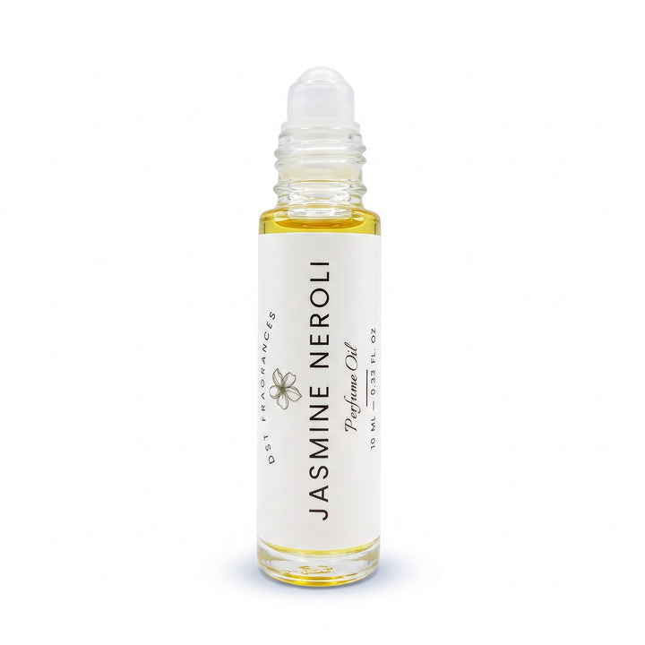 A clear glass rollerball bottle filled with pale yellow jasmine neroli perfume oil, featuring a white label with black text and a small flower illustration. The bottle is centered on a clean white background.