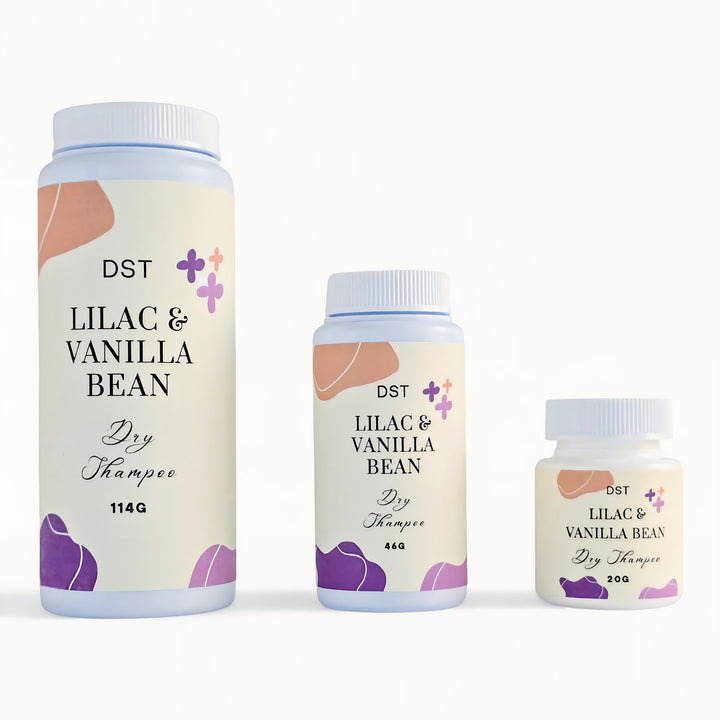 Three bottles of DST Lilac & Vanilla Bean Dry Shampoo on a white background