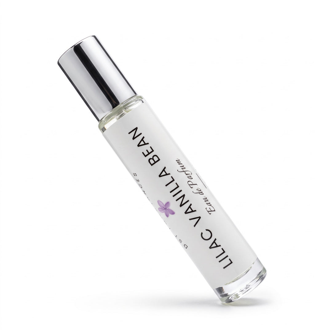 A clear glass roll-on perfume bottle with a reflective silver cap, labeled &