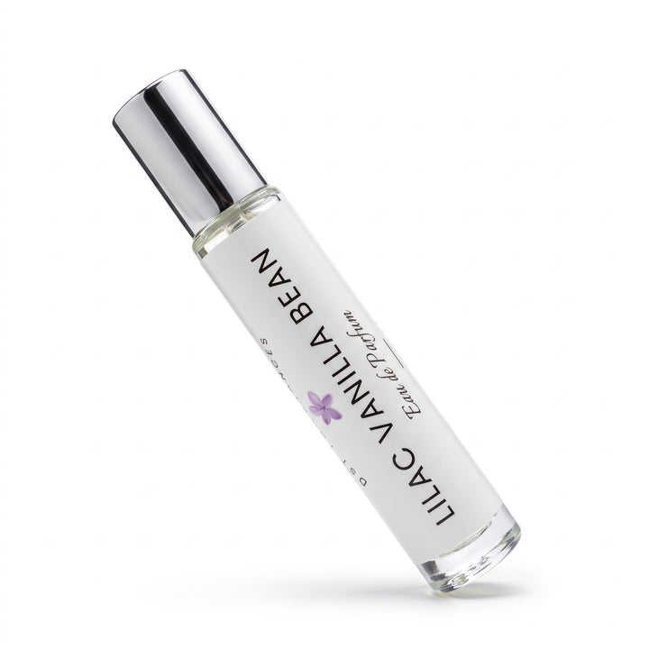 A clear glass roll-on perfume bottle with a reflective silver cap, labeled &