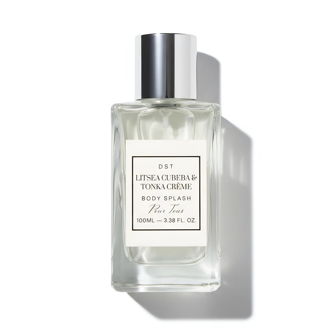 Clear bottle of Litsa Cuba & Tonka Creme body splash with silver cap on a white background