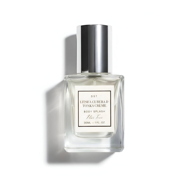 Clear perfume bottle with silver cap on a white background