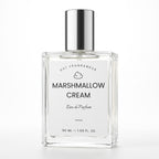 A 50 ml clear glass perfume bottle with a silver cap and a white label reading 'MARSHMALLOW CREAM' by DST Fragrances, on a white background.