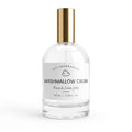 A clear glass bottle of room and linen spray with a white label reading 'Marshmallow Cream' by DST Fragrances, topped with a metallic gold cap, on a white background.