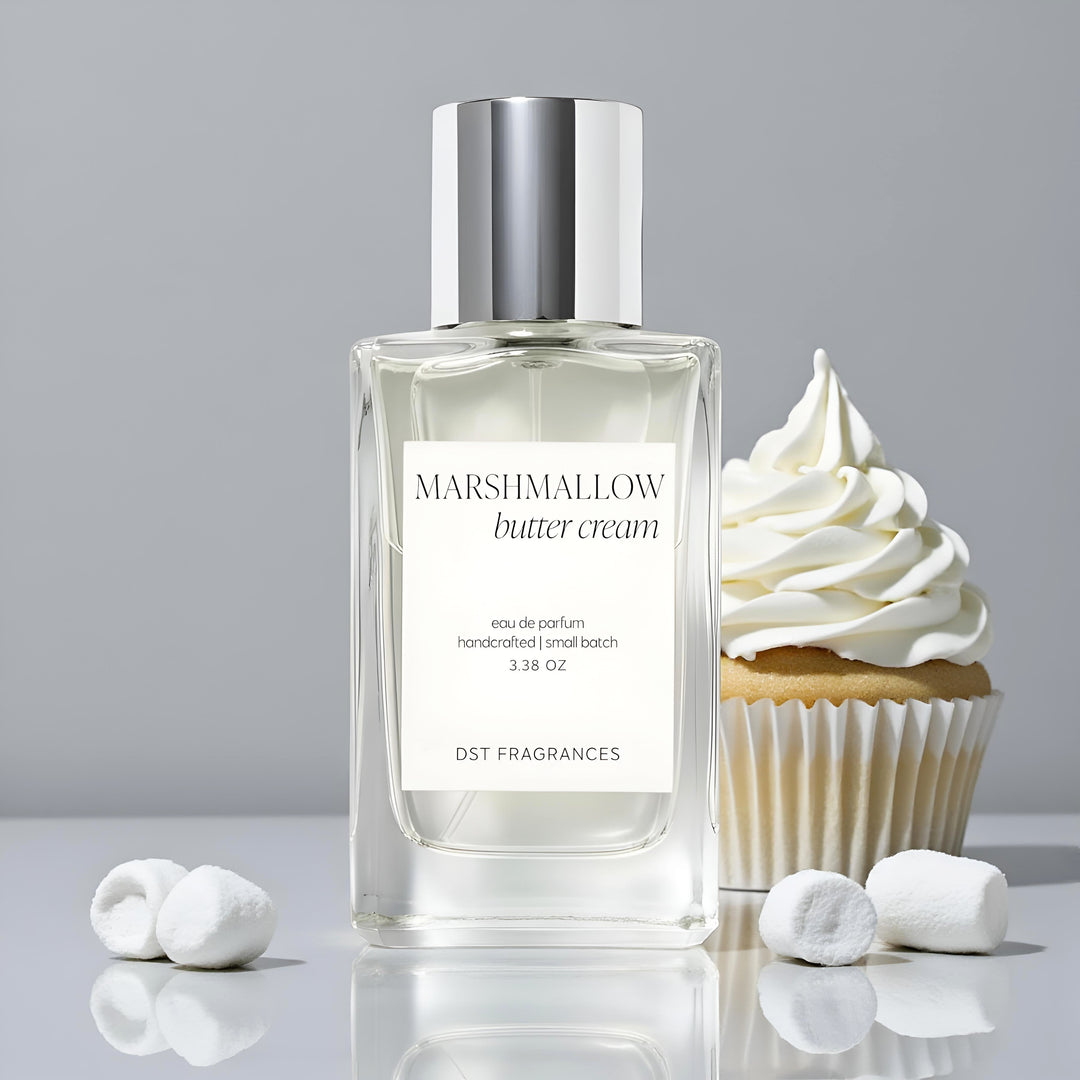 Marshmallow butter cream perfume bottle by DST Fragrances with a cupcake and marshmallows on a gray background