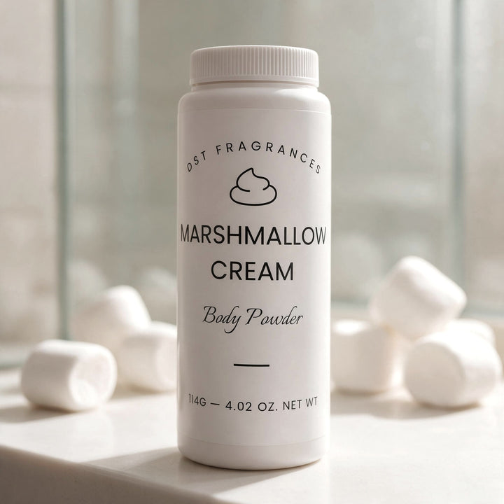 A white plastic bottle of DST Fragrances Marshmallow Cream Body Powder stands on a light stone surface with blurred marshmallows in the background.