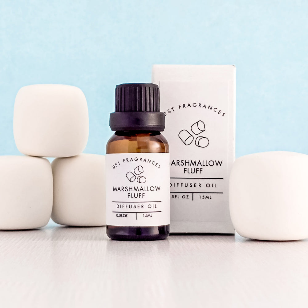 Diffuser oil bottle labeled 'Marshmallow Fluff' with packaging on a light blue background