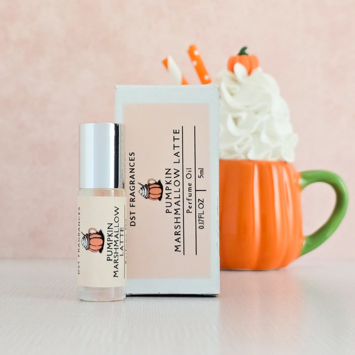 Perfume bottle and packaging of Pumpkin Marshmallow Latte by DST Fragrances with a pumpkin-themed cup in the background.