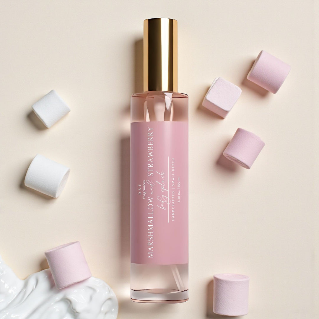 Pink bottle of Marshmallow Strawberry body oil with scattered cubes on a beige background