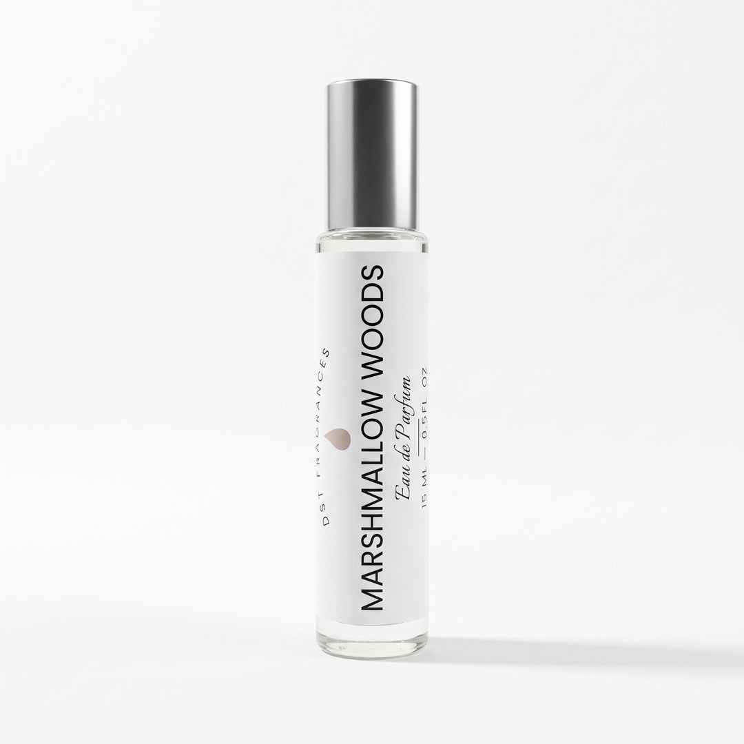 A clear glass spray bottle with a reflective silver cap, featuring a white label with black text that reads &