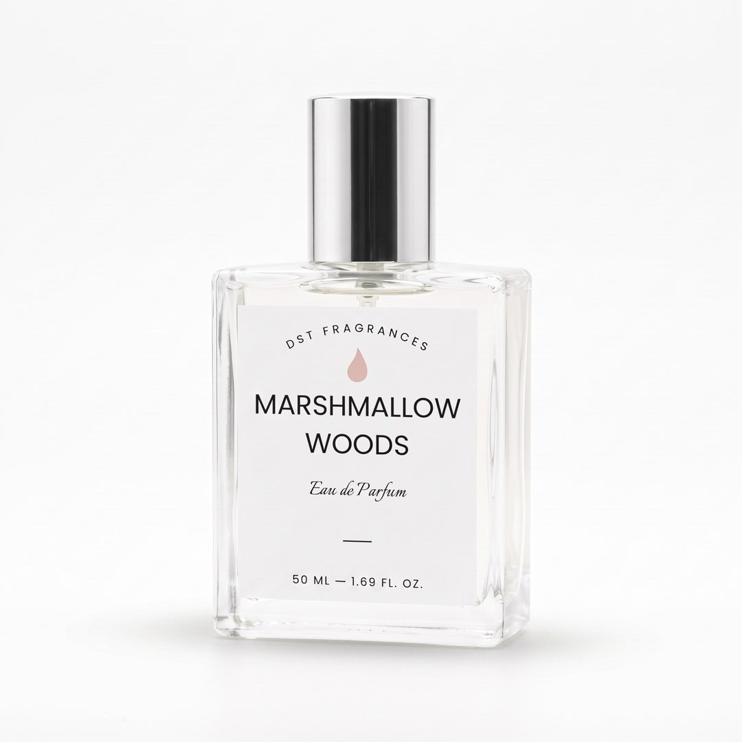 A clear glass perfume bottle with a reflective silver cap and a white label reading &