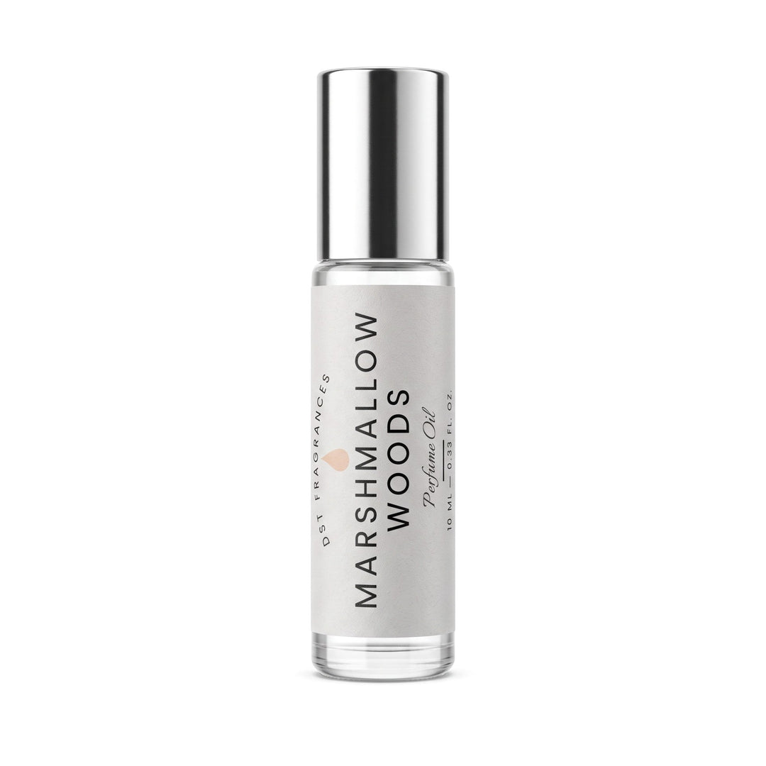 Marshmallow Woods Perfume Oil rollerball bottle by Oct Fragrance, featuring a clear glass bottle, silver cap, and a light gray label with black text.