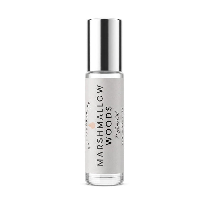 Marshmallow Woods Perfume Oil rollerball bottle by Oct Fragrance, featuring a clear glass bottle, silver cap, and a light gray label with black text.