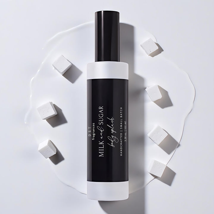 Black and white body splash bottle with 'Milk & Sugar' branding on a light gray background
