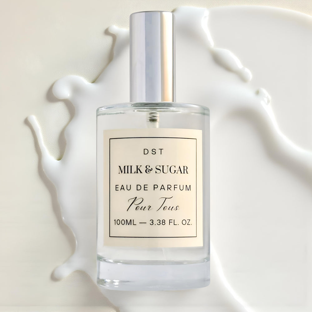 Milk Sugar Eau de Parfum bottle laying against spilled mi