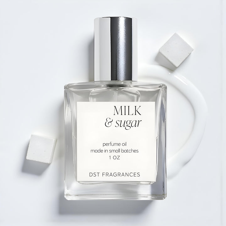 Perfume oil bottle labeled 'Milk & Sugar' on a light gray background