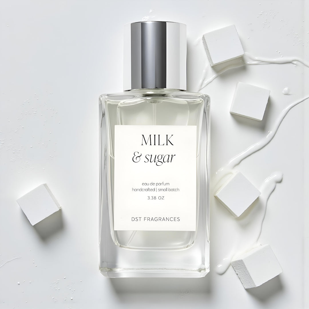 100ml bottle of Milk Sugar Eau de Parfum by DST Fragrances laying on a light grey surface with spilled milk and white sugar cubes in the background.