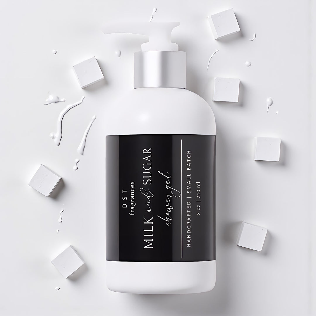 240ml bottle of Milk and Sugar Scented Shower Gel by DST Fragrances laying on a light grey surface with splashes of white milk and white sugar cubes surrounding the bottle.