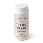A white plastic bottle of DST Fragrances Orange Sherbet Body Powder, featuring a cream-colored label with black text and a small orange slice graphic, set against a plain white background.