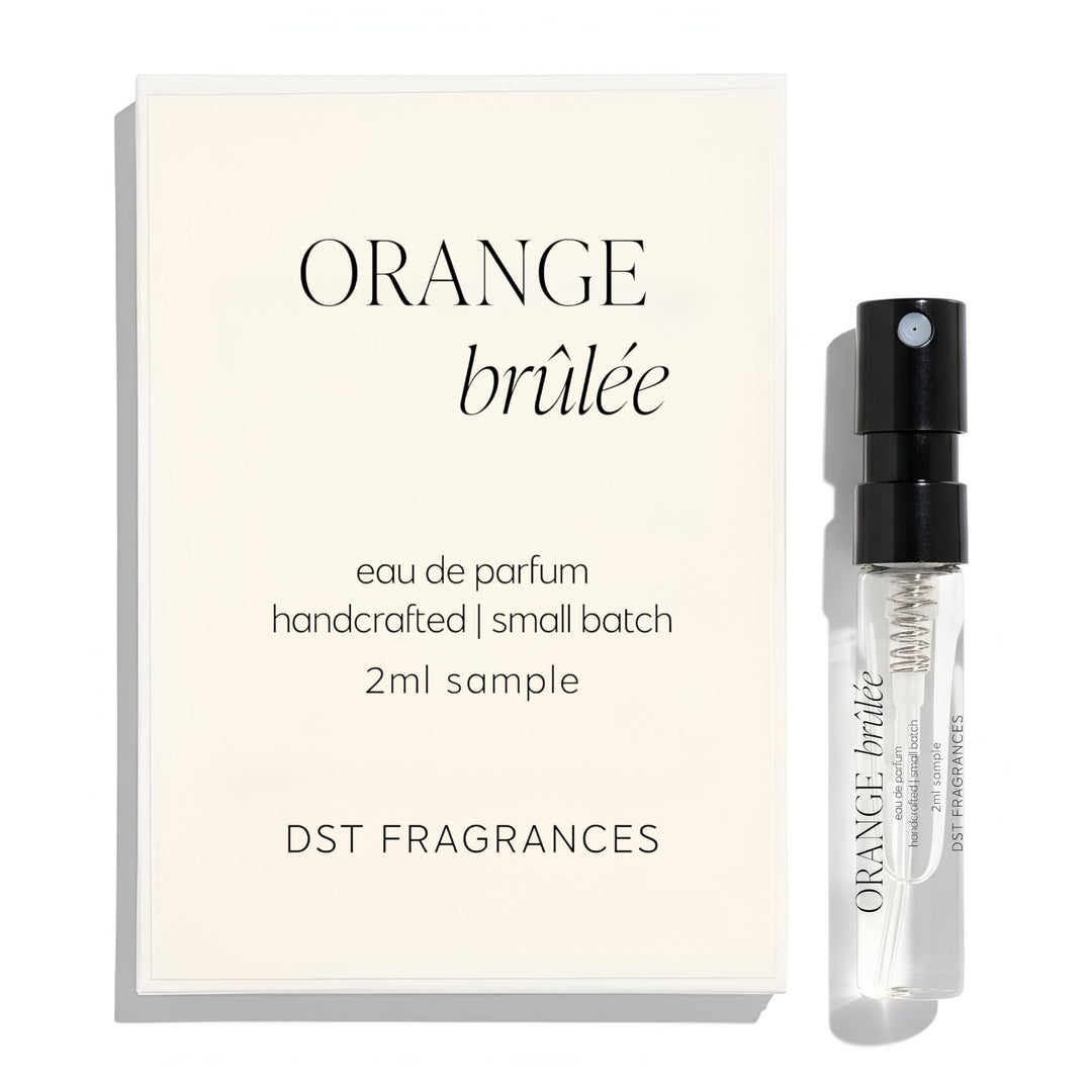 2ml sample spray vial of Orange Brulee scented Eau de Parfum by DST Fragrances against a white background.
