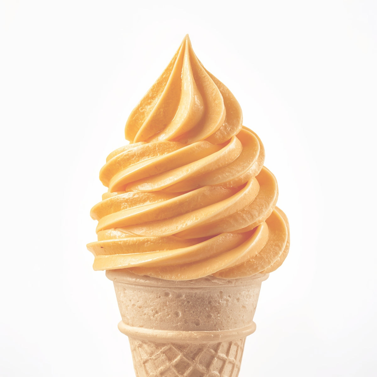 A swirl of soft vanilla ice cream in a light brown waffle cone, centered on a clean white background.