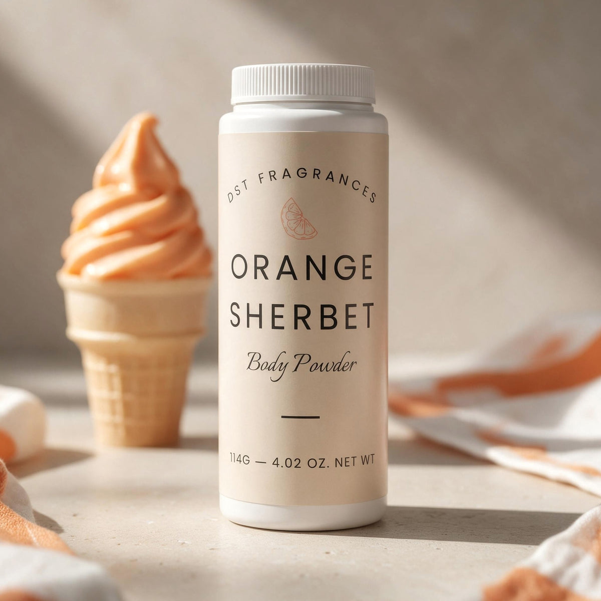 A bottle of DST Fragrances Orange Sherbet Body Powder stands on a light stone surface with a soft-focus orange sherbet cone in the background.
