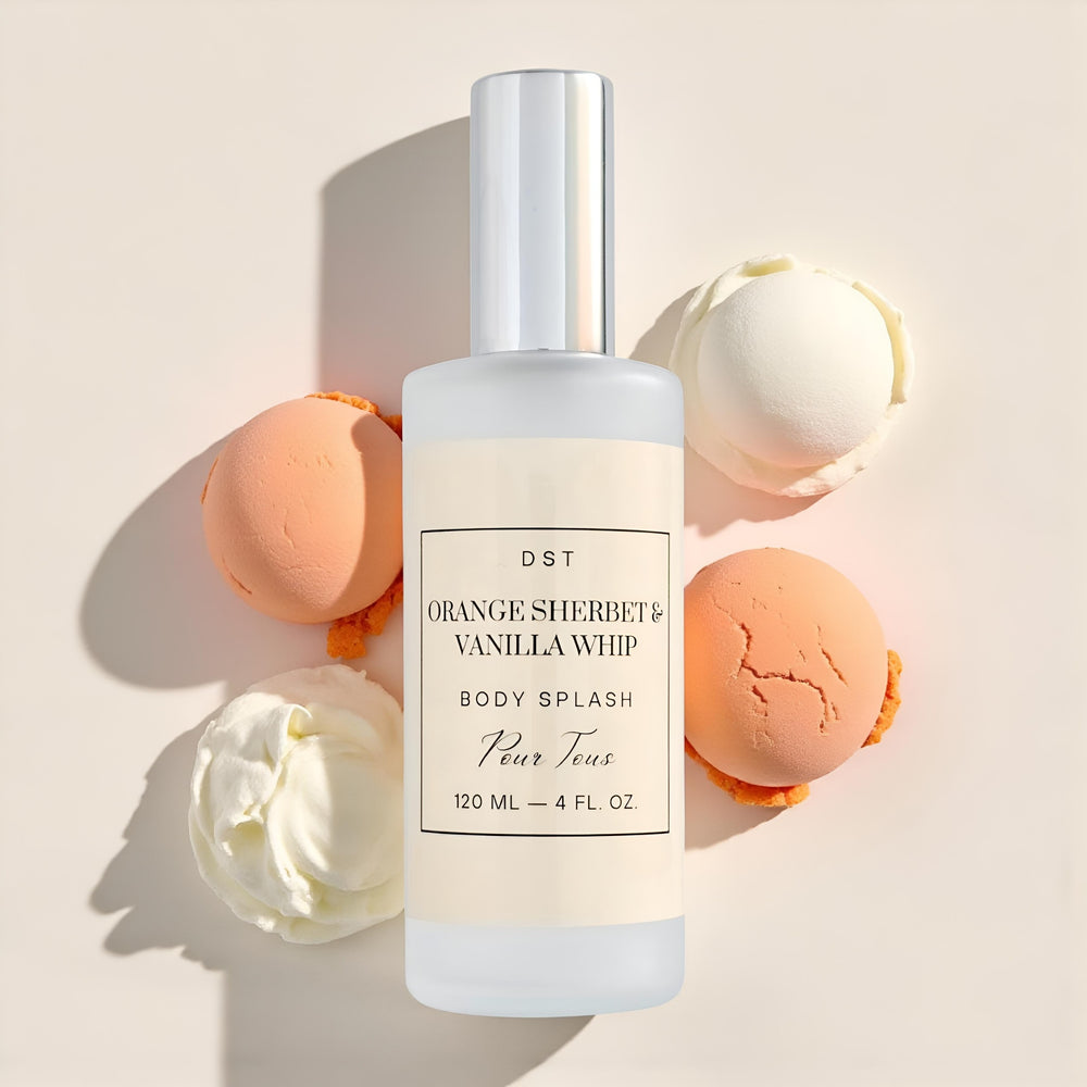 Fragrance bottle labeled 'Orange Sherbet Vanilla Whip' with an ice cream cone container and packaging on a wooden surface.